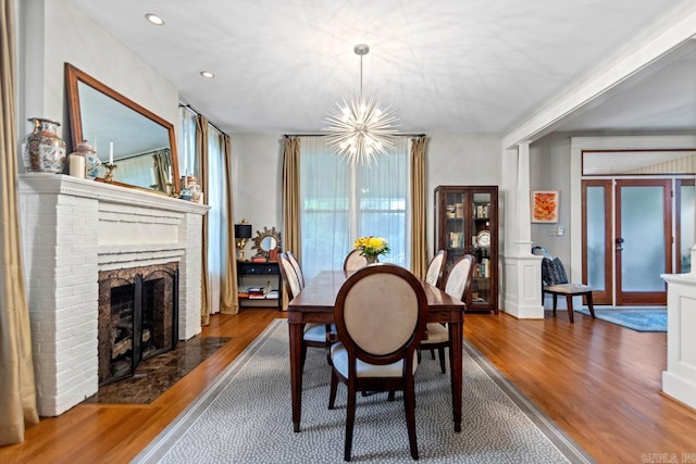 1116 Kavanaugh Blvd, Little Rock, AR 72205 - dining space with wood finished floors, a chandelier, a fireplace, and recessed lighting