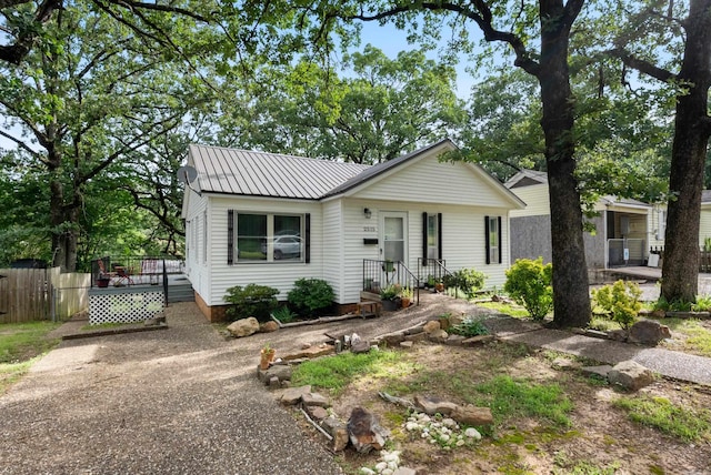 2515 N Dr, North Little Rock, AR 72118 - view of front of property with a deck, a metal roof, and dirt driveway