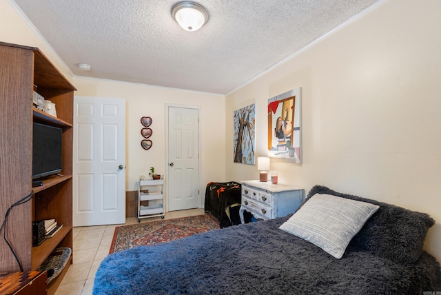 2515 N Dr, North Little Rock, AR 72118 - bedroom with a textured ceiling, light tile patterned floors, and ornamental molding