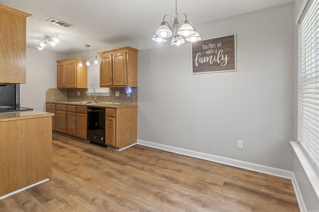 70 Peach St, Austin, AR 72007 - kitchen featuring black dishwasher, tasteful backsplash, light wood-type flooring, a chandelier, and hanging light fixtures
