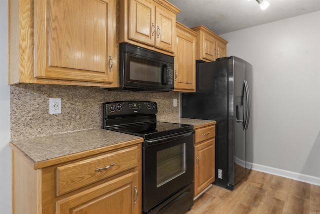 70 Peach St, Austin, AR 72007 - kitchen featuring black appliances, backsplash, light wood finished floors, and light countertops