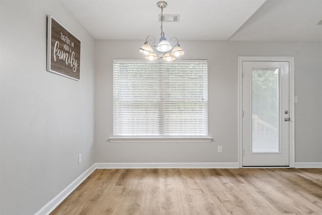 70 Peach St, Austin, AR 72007 - unfurnished dining area with a chandelier, wood finished floors, and healthy amount of natural light