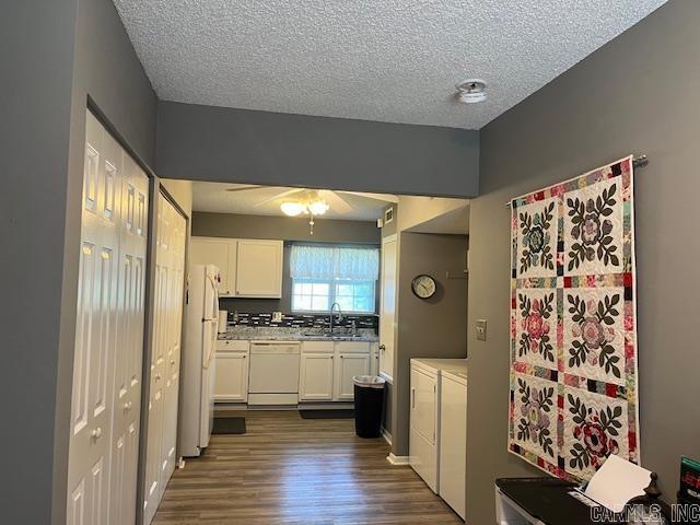 600 Higdon Ferry Rd Unit 301, Hot Springs, AR 71913 - kitchen featuring white appliances, separate washer and dryer, white cabinets, dark wood-style floors, and a textured ceiling