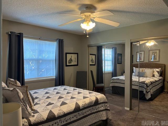 600 Higdon Ferry Rd Unit 301, Hot Springs, AR 71913 - bedroom with dark colored carpet, multiple closets, ceiling fan, and a textured ceiling