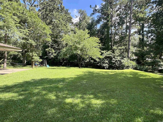 114 Mark Cir, Monticello, AR 71655 - view of green lawn with a playground