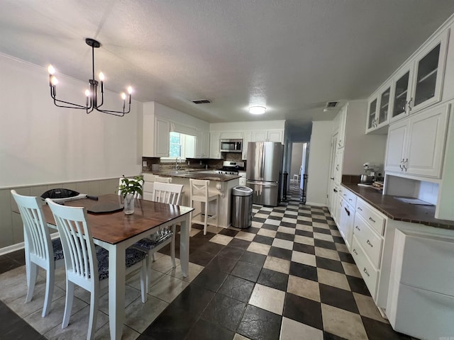 114 Mark Cir, Monticello, AR 71655 - dining room with a chandelier and a textured ceiling