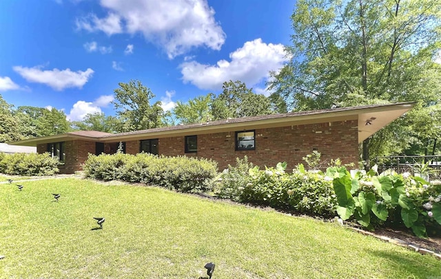 114 Mark Cir, Monticello, AR 71655 - view of front facade featuring a front lawn and brick siding