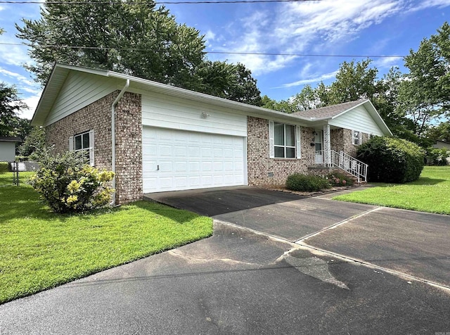 504 Case St, Heber Springs, AR 72543 - ranch-style house with brick siding, asphalt driveway, an attached garage, and a front lawn
