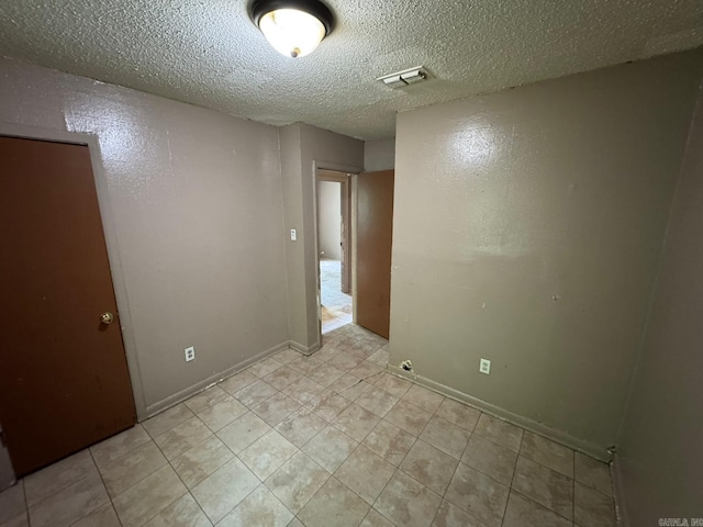 4114 W 10th Ave, Pine Bluff, AR 71603 - unfurnished room with a textured ceiling and light tile patterned floors