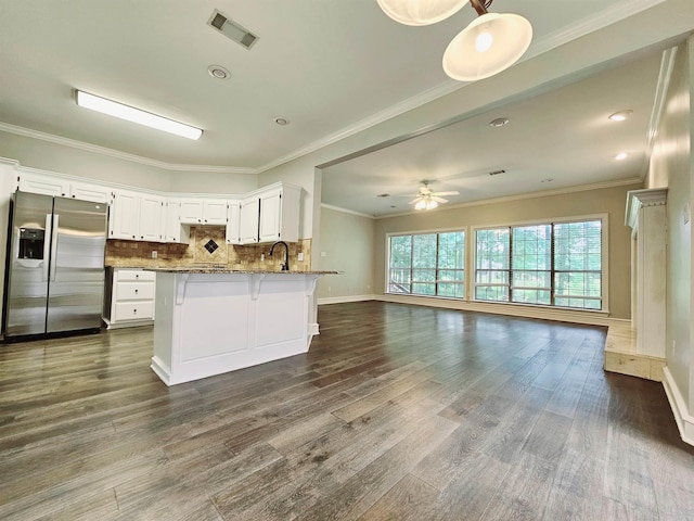 158 Calais, Maumelle, AR 72113 - kitchen with stainless steel refrigerator with ice dispenser, open floor plan, dark wood finished floors, a ceiling fan, and decorative backsplash