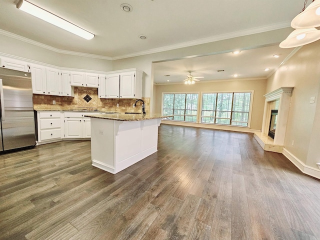 158 Calais, Maumelle, AR 72113 - kitchen featuring stainless steel fridge, light stone counters, dark wood-style floors, white cabinets, and open floor plan