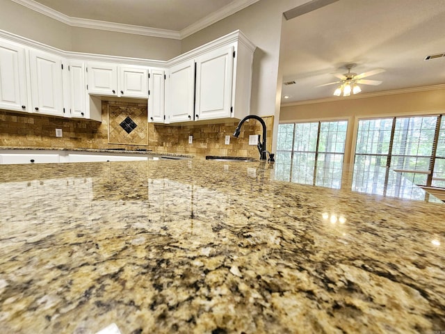 158 Calais, Maumelle, AR 72113 - kitchen featuring light stone counters, ornamental molding, white cabinetry, tasteful backsplash, and a ceiling fan