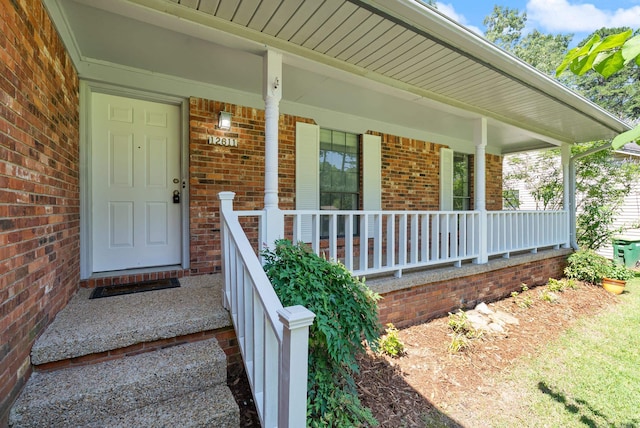12611 Timber Bend Dr, Little Rock, AR 72211 - view of exterior entry with brick siding and a porch