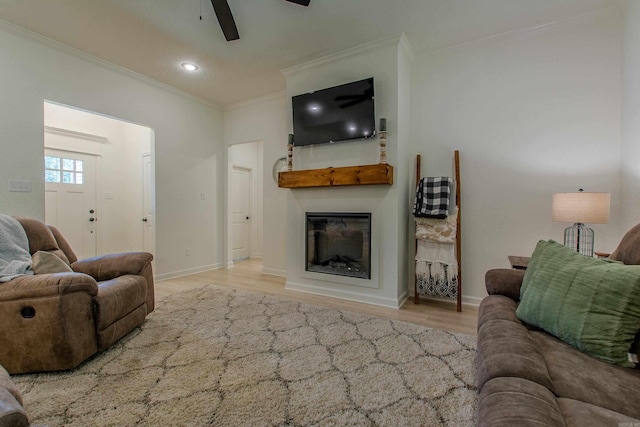 18508 Parkway Pines Dr, Bauxite, AR 72011 - living area featuring ceiling fan, ornamental molding, wood finished floors, a glass covered fireplace, and recessed lighting