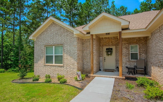 18508 Parkway Pines Dr, Bauxite, AR 72011 - view of front facade with a front yard, brick siding, and a shingled roof