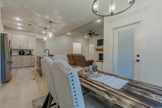 18508 Parkway Pines Dr, Bauxite, AR 72011 - dining space with light wood finished floors, recessed lighting, a ceiling fan, crown molding, and a chandelier