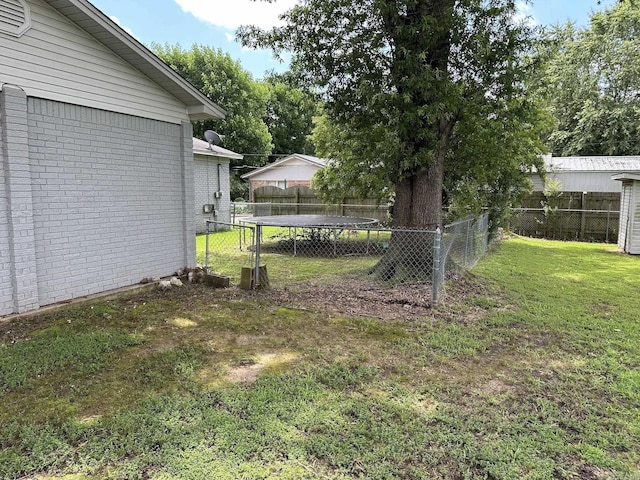 207 Byron St, Beebe, AR 72012 - fenced backyard featuring a trampoline