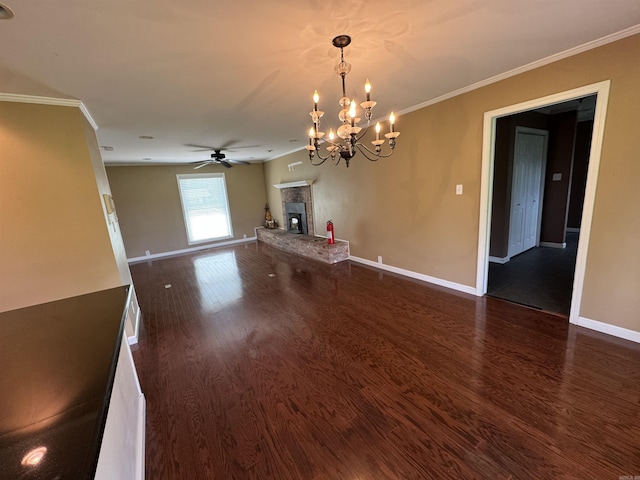 2025 Fairway St, Stuttgart, AR 72160 - unfurnished living room featuring dark wood finished floors, ceiling fan, a chandelier, a glass covered fireplace, and crown molding