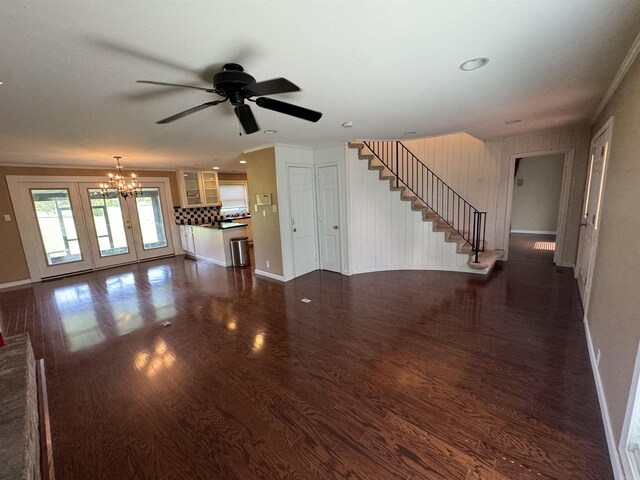 2025 Fairway St, Stuttgart, AR 72160 - unfurnished living room with a ceiling fan, a chandelier, dark wood-style floors, and stairway