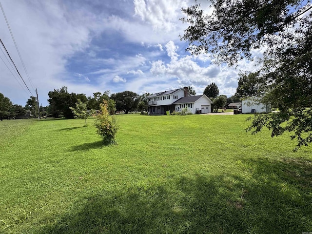 2025 Fairway St, Stuttgart, AR 72160 - view of green lawn with a garage