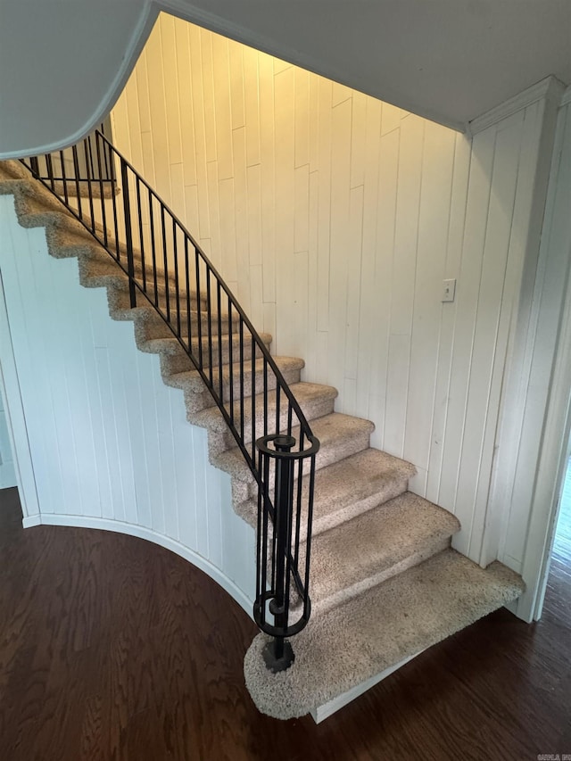 2025 Fairway St, Stuttgart, AR 72160 - staircase with wood finished floors and wood walls