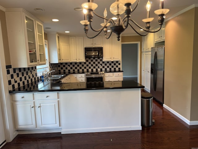 2025 Fairway St, Stuttgart, AR 72160 - kitchen featuring stainless steel appliances, a chandelier, dark countertops, decorative backsplash, and recessed lighting