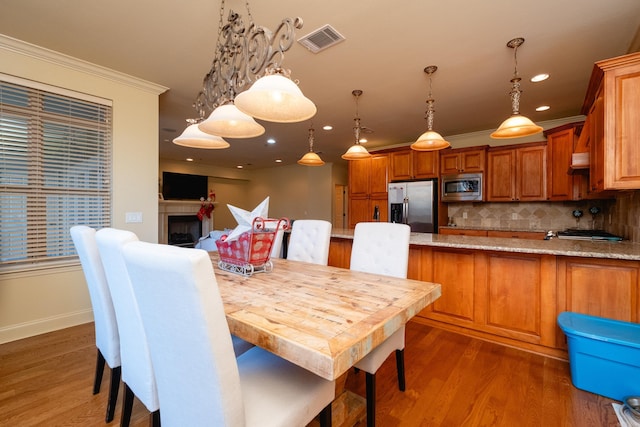 100 Vallon Ln, Little Rock, AR 72223 - dining area with dark wood finished floors, ornamental molding, recessed lighting, and a fireplace