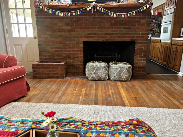 102 Mockingbird Ln, Arkadelphia, AR 71923 - detailed view of white oven, wood finished floors, and a brick fireplace