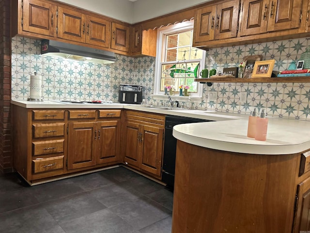 102 Mockingbird Ln, Arkadelphia, AR 71923 - kitchen with under cabinet range hood, tasteful backsplash, light countertops, brown cabinets, and open shelves