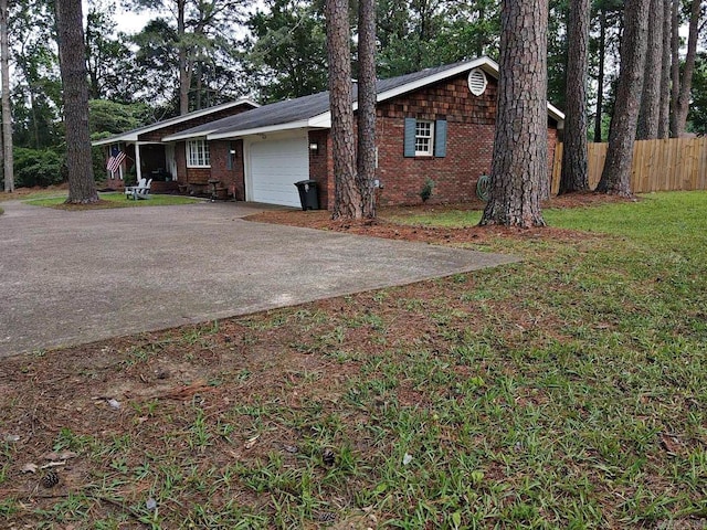 102 Mockingbird Ln, Arkadelphia, AR 71923 - view of side of property with a garage, concrete driveway, and brick siding