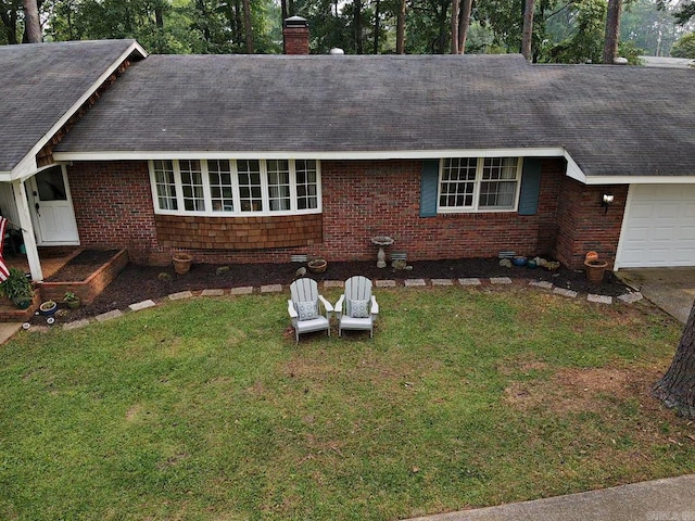 102 Mockingbird Ln, Arkadelphia, AR 71923 - view of front of property featuring a chimney, a front yard, an attached garage, brick siding, and a shingled roof