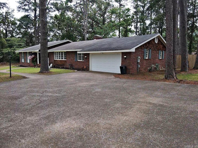 102 Mockingbird Ln, Arkadelphia, AR 71923 - single story home featuring asphalt driveway, an attached garage, brick siding, and a chimney