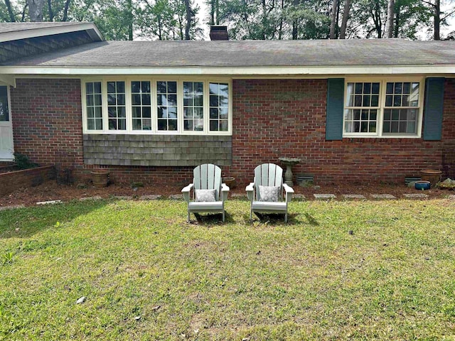 102 Mockingbird Ln, Arkadelphia, AR 71923 - view of side of home featuring a yard, a chimney, and brick siding