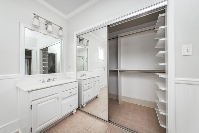 4106 C St, Little Rock, AR 72205 - bathroom featuring crown molding, vanity, a wainscoted wall, and tile patterned flooring