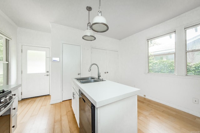 4106 C St, Little Rock, AR 72205 - kitchen with dishwasher, stainless steel gas stove, light wood-style floors, and light countertops