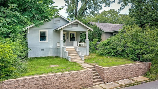 4106 C St, Little Rock, AR 72205 - view of front of home with stairs, a porch, and a front lawn
