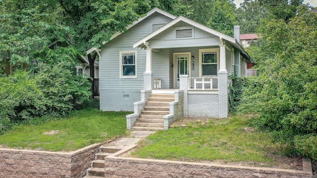 4106 C St, Little Rock, AR 72205 - bungalow-style house with a porch, stairway, a chimney, and a front yard