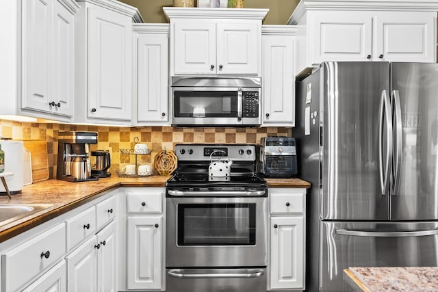 27 Magnolia Ln, Ward, AR 72176 - kitchen with appliances with stainless steel finishes, white cabinetry, and decorative backsplash