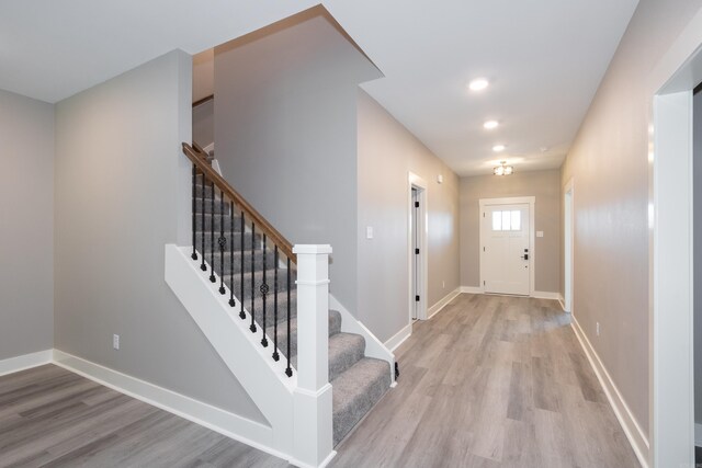 entrance foyer with light wood-type flooring and stairway