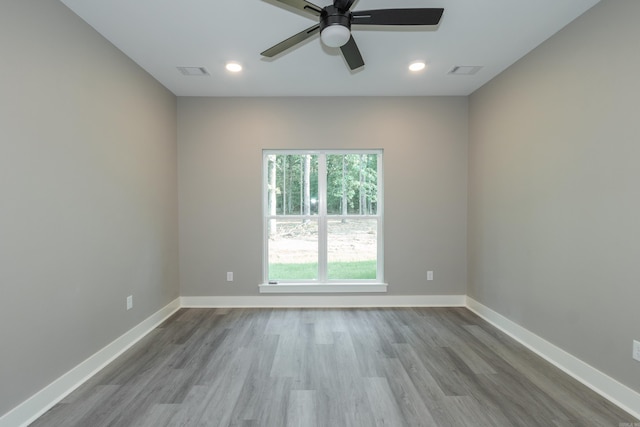 empty room with a ceiling fan, wood finished floors, and recessed lighting