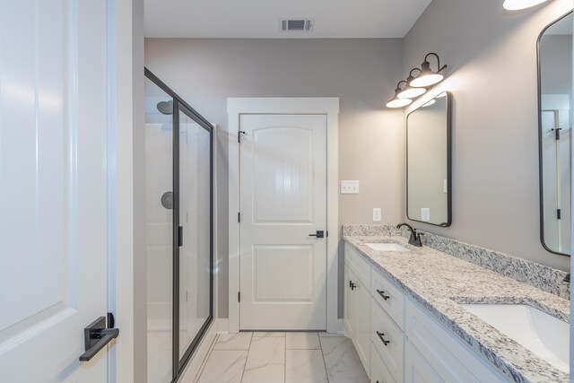 full bathroom with a stall shower, double vanity, and marble finish flooring