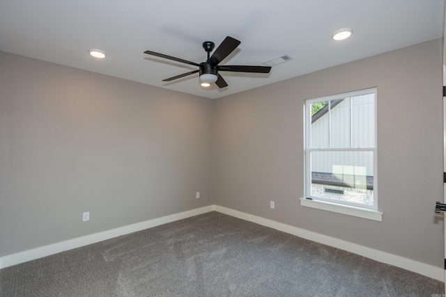 spare room with a ceiling fan, dark colored carpet, and recessed lighting