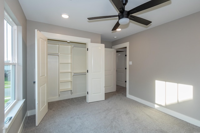 unfurnished bedroom with light carpet, a closet, a ceiling fan, and recessed lighting
