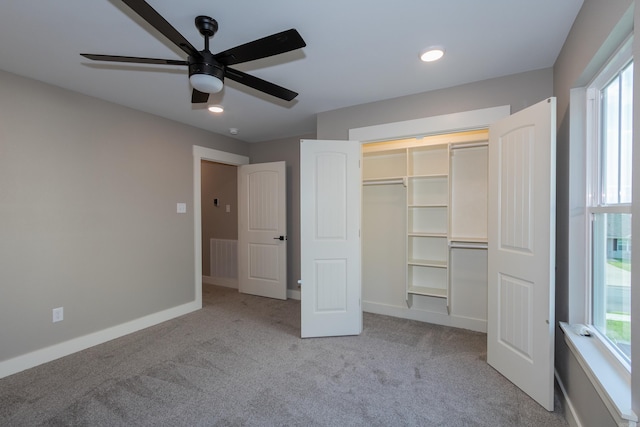 unfurnished bedroom with light colored carpet, a closet, a ceiling fan, and recessed lighting
