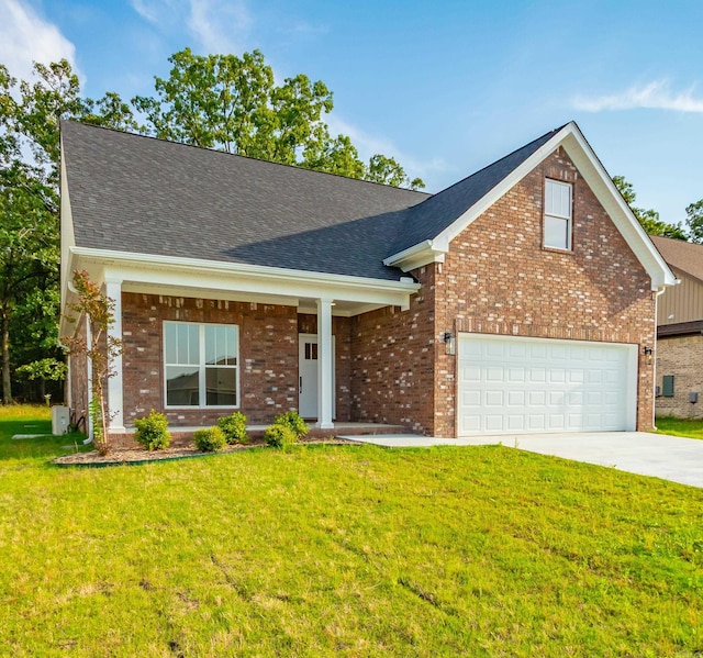 view of front of home featuring brick siding, driveway, a shingled roof, and a front yard