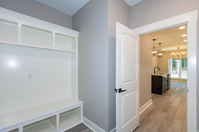 mudroom featuring a chandelier, light wood-style floors, and recessed lighting