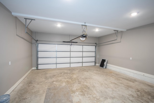 garage featuring a garage door opener and baseboards