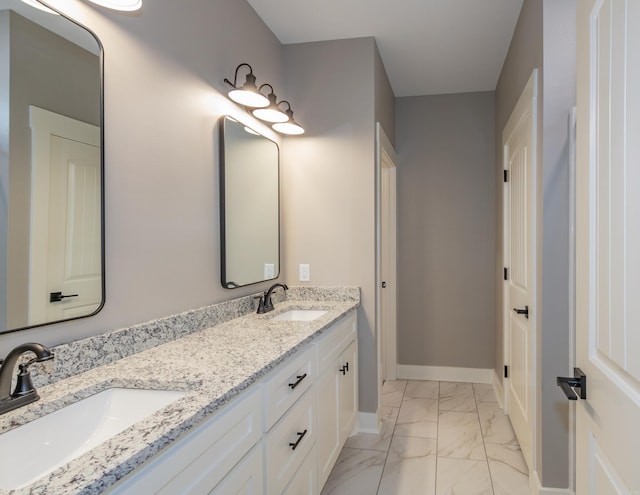 full bathroom with marble look tile flooring and double vanity