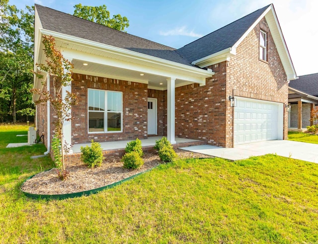 traditional-style home with brick siding, a front lawn, driveway, and covered porch