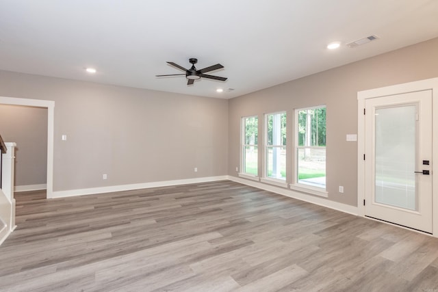 empty room with ceiling fan, light wood-style flooring, and recessed lighting